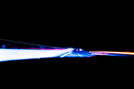 Cars light trails on a curved highway at night. Night traffic trails. Motion blur. Night city road...