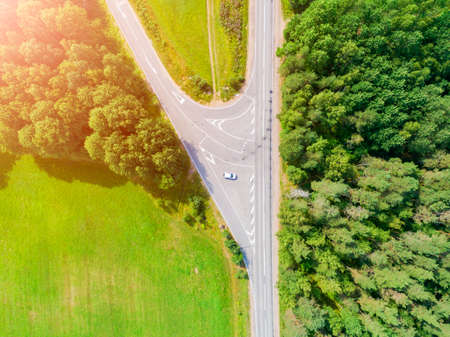 Aerial view of highway in city. Cars crossing interchange overpass. Highway interchange with...
