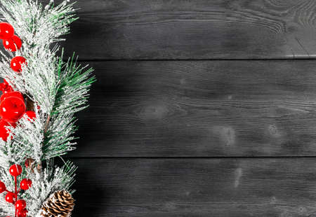 Christmas concept. Christmas fir tree with decoration on rustic vintage board. Pine branches. Fir cones. Snow on wood. Xmas and Happy New Year composition. Copy space. Empty space. Top view. Christmas backgroundの写真素材