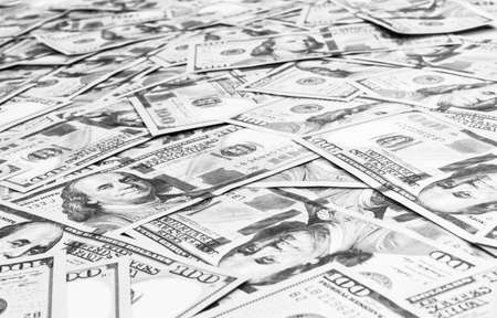 Stack of one hundred dollar bills. Stack of cash money in hundred dollar banknotes. Heap of hundred dollar bills background. Concept of financial success. Black and white. Money backgroundの写真素材
