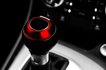 Close up view of a red gear lever shift. Manual gearbox. Car interior details. Car transmission....