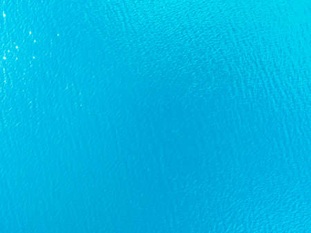 Aerial view of a Crystal clear sea water texture. View from above Natural blue background. Turquoise...