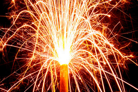 Burning christmas sparklers with long exposure. Beautiful sparkler firework flame on black...