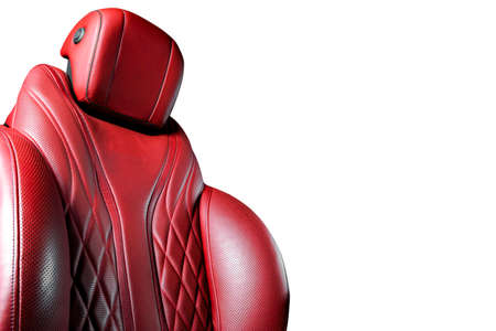 Red leather interior of the luxury modern car. Perforated red leather comfortable seats with stitching isolated on white background. Modern car interior details. Car detailing. Car insideの写真素材
