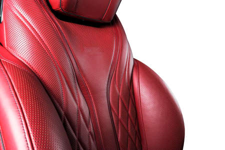 Red leather interior of the luxury modern car. Perforated red leather comfortable seats with stitching isolated on white background. Modern car interior details. Car detailing. Car insideの写真素材