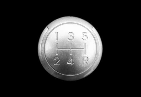 Close up view of a manual gear lever shift isolated on black background. Manual gearbox. Car interior details. Car transmission. Soft lighting. Abstract view. Car detailing. Top viewの写真素材