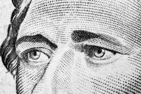 Close up view Portrait of Alexander Hamilton on the one ten dollar bill. Background of the money. 10 dollar bill with Alexander Hamilton eyes macro shot. Money background. Face portrait. Black and whiteの写真素材