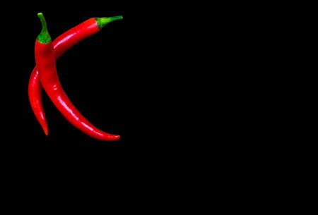 Red hot chilli pepper isolated on black background.
