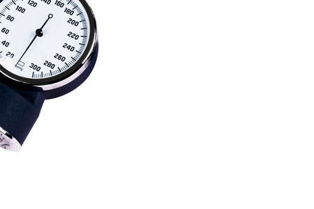 A Blood pressure manometer on a cardiogram (ECG) isolated on white background. Aneroid sphygmomanometer. Medical healthcare.の写真素材