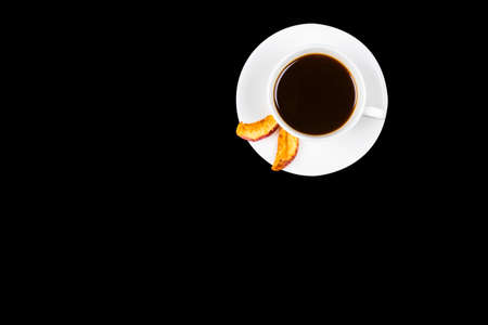 Cup of black coffee isolated on black background. Mock up. Cup of Black Coffee in White Ceramic Cup on plastic Tabletop.の写真素材