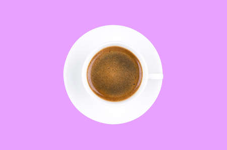 Overhead view of a freshly brewed mug of espresso coffee isolated on purple background. Coffee break style concept.の写真素材