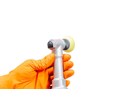 Car polish wax worker hands holing polishing tools in protective gloves isolated on white background. Buffing and polishing car concept. Man holds a polisher in the hand and polishes.の写真素材