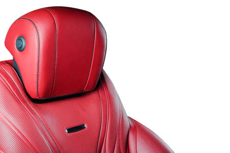 Red leather interior of the luxury modern car. Perforated red leather comfortable seats with stitching isolated on white background. Modern car interior details. Car detailing. Car insideの写真素材