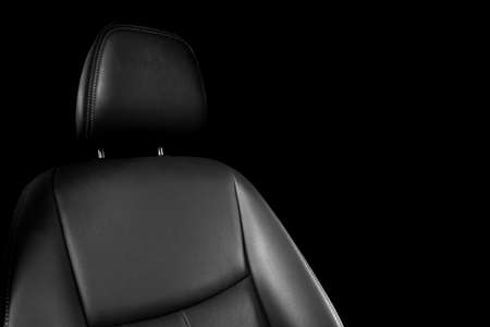 Black leather interior of the luxury modern car. Perforated Leather comfortable seats with stitching isolated on black background. Modern car interior details. Car detailing. Car insideの写真素材