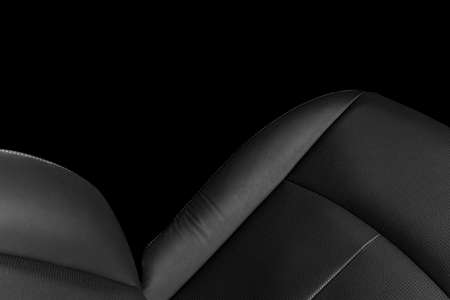 Black leather interior of the luxury modern car. Perforated Leather comfortable seats with stitching isolated on black background. Modern car interior details. Car detailing. Car insideの写真素材