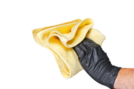 Washing concept. A male man hand with cloth isolated on white background. Worker cleaning. Cleaning with cloth, foam and brush. Cleaning concept. Hand in black protective rubber gloveの写真素材