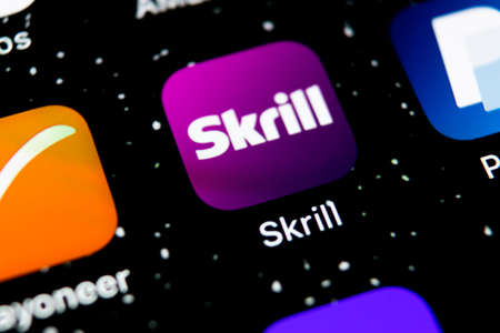 Sankt-Petersburg, Russia, February 3, 2019: Skrill application icon on Apple iPhone X smartphone screen close-up. Skrill app icon. Skrill is an online electronic finance payment system.のeditorial素材