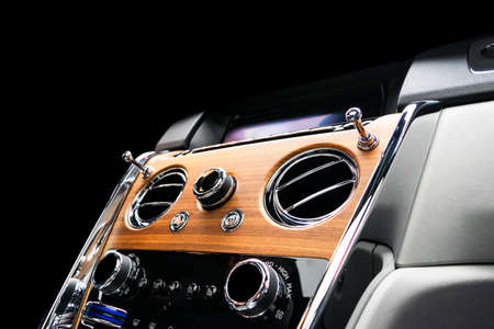 Modern Luxury sport car inside. Interior of prestige vehicle with natural wood panel. White Leather...