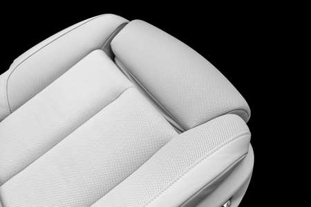 White leather interior of the luxury modern car. Perforated white leather comfortable seats with...