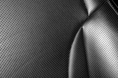 Modern luxury car leather interior. Part of leather car seat details with white stitching. Interior...