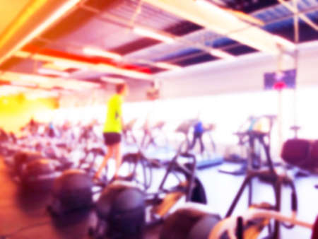 Blurred background with fitness gym people cardio workout in sport club center. Blurred picture of...