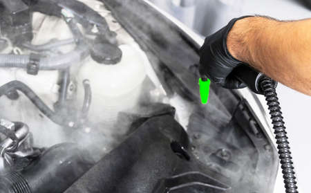 Car detailing. Washing and cleaning engine. Cleaning car engine using hot steam. Hot steam engine...