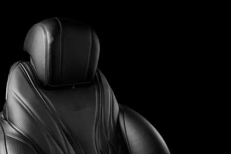 Black leather interior of the luxury modern car. Perforated leather comfortable seats with stitching isolated on black background. Modern car interior details. Car detailing. Black and whiteの写真素材