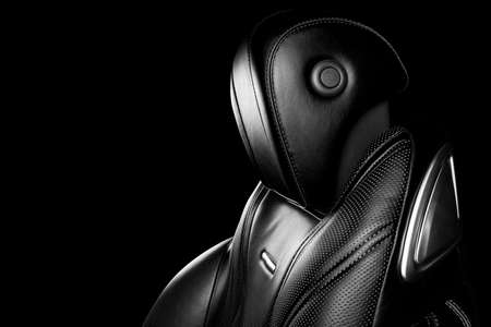 Black leather interior of the luxury modern car. Perforated leather comfortable seats with stitching...
