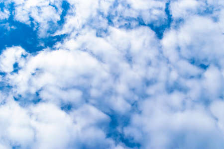 Nature background. White clouds over blue sky. Blue sky with clouds and sun.