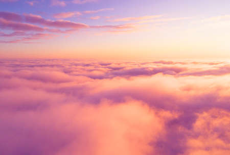 Aerial view White clouds in blue sky. Top view. View from drone. Aerial bird's eye view. Aerial top view cloudscape. Texture of clouds. View from above. Sunrise or sunset over cloudsの写真素材