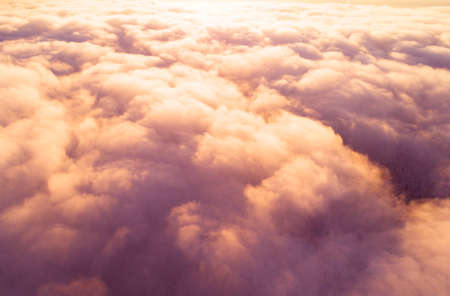 Aerial view White clouds in blue sky. Top view. View from drone. Aerial bird's eye view. Aerial top view cloudscape. Texture of clouds. View from above. Sunrise or sunset over cloudsの写真素材