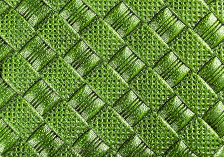 Green perforated leather texture. Close up shot. Leather background. Macro shot. The look of genuine...