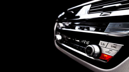 Air conditioning red button inside a car. Climate control AC unit in the new car. Modern car white...