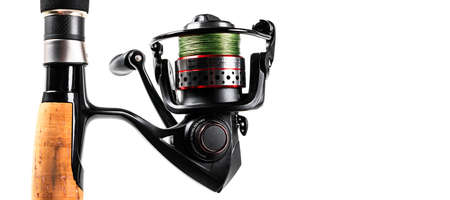 Fishing rod spinning with the line close-up. Fishing rod and reel isolated on white background....