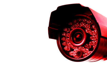 Red CCTV security camera video equipment. Surveillance monitoring. Video camera lens closeup. Macro...