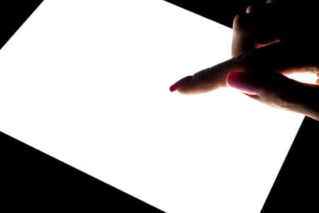 Tablet computer mockup in woman hand isolated on black background. Tablet laptop mockup with blank white screen at night. Empty space for text. Copy space. Isolated screen. Clipping pathの写真素材