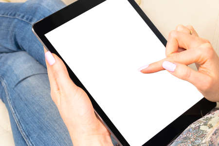 Tablet mockup in woman hand with clipping path. Modern tablet computer mock up with blank white...