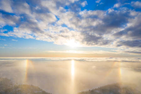 Aerial view White clouds in blue sky with solar halo. Top view. View from drone. Aerial bird's eye...