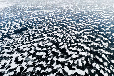 Aerial view of a frozen lake surface. Aerial Snow pattern on the frozen lake. Frozen lake ice...