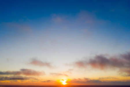 Aerial view sunset over the forest and lake. Top view. View from drone. Aerial top view cloudscape. Texture of clouds. View from above. Sunrise or sunset over cloudsの写真素材