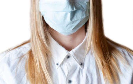 Woman wearing protective face mask. Doctor wearing a surgical mask isolated on a white background. COVID-19 pandemic coronavirus. Woman with face mask protectiveの写真素材