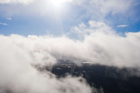 Aerial view clouds over the forest and lake. View from drone. Aerial top view cloudscape. Texture of clouds. View from above. Sunrise or sunset over cloudsの写真素材