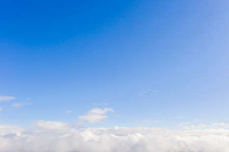 Aerial view white clouds in blue sky. View from drone. Aerial top view cloudscape. Texture of clouds. View from above. Sunrise or sunset over clouds. Panorama cloudsの写真素材