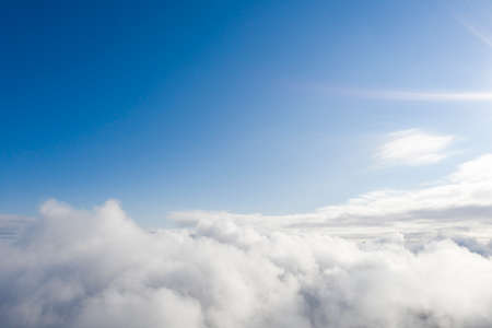 Aerial view white clouds in blue sky. View from drone. Aerial top view cloudscape. Texture of clouds. View from above. Sunrise or sunset over clouds. Panorama cloudsの写真素材