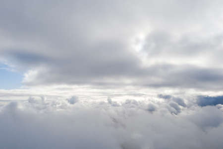 Aerial view white clouds in blue sky. View from drone. Aerial top view cloudscape. Texture of clouds. View from above. Sunrise or sunset over clouds. Panorama cloudsの写真素材