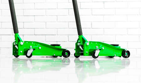 Hydraulic car floor jacks. Car Lift. Green Hydraulic Floor Jack For car Repairing. Extra safety measures.の写真素材