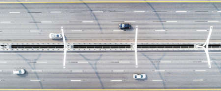 Aerial view of highway. Cars crossing bridge interchange overpass. Highway interchange with traffic....