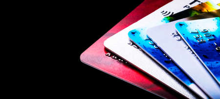 Credit card isolated on black background. Macro shot. Close Up Credit card payment. Macro shot of...