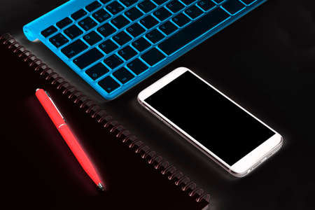 Abstract business workplace. Office table with computer, wireless computer keyboard and smartphone. Copy space. Empty screenの写真素材