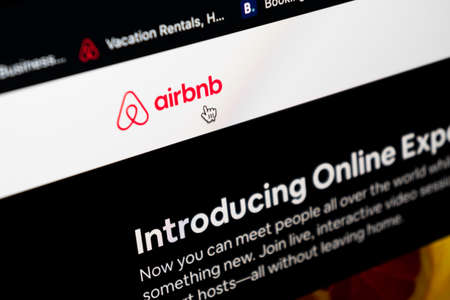 Sankt-Petersburg, Russia, May 11, 2020: Airbnb application homepage on Apple iMac screen close-up. Airbnb app icon. Airbnb.com is online website for booking rooms.のeditorial素材